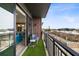 Cozy outdoor balcony with artificial turf, railing and seating area with a partial view of the neighborhood at 22 Airline Ne St # 403, Atlanta, GA 30312