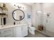 Modern bathroom with glass enclosed shower, white vanity, modern mirror, and a small wooden seat at 22 Airline Ne St # 403, Atlanta, GA 30312