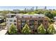 A multi-story brick apartment building with city views, top-floor balconies, and mature trees around the property at 22 Airline Ne St # 403, Atlanta, GA 30312