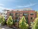 Brick apartment building with balconies and rooftop deck beneath a brilliant blue sky at 22 Airline Ne St # 403, Atlanta, GA 30312