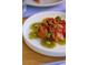 Close-up of a vibrant fruit salad with oranges and kiwis on a white plate at 22 Airline Ne St # 403, Atlanta, GA 30312