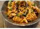 Close-up of dumplings topped with sesame seeds and scallions in a savory sauce at 22 Airline Ne St # 403, Atlanta, GA 30312