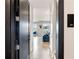 Apartment hallway leading to a bright living space with a blue sofa at 22 Airline Ne St # 403, Atlanta, GA 30312