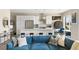 Open-concept kitchen with white cabinetry, stainless appliances, and island seating connected to living area at 22 Airline Ne St # 403, Atlanta, GA 30312