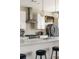 Close up of a kitchen with stainless steel hood and appliances, white subway tile backsplash, and breakfast bar seating at 22 Airline Ne St # 403, Atlanta, GA 30312