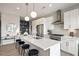 Modern kitchen features stainless steel appliances, white cabinetry, and a quartz countertop island with seating at 22 Airline Ne St # 403, Atlanta, GA 30312