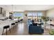 Bright, open-concept living space featuring hardwood floors, modern kitchen, and a comfortable seating area with balcony access at 22 Airline Ne St # 403, Atlanta, GA 30312