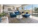 Stylish living room with a large blue sectional sofa, modern rug, and access to a balcony with city views at 22 Airline Ne St # 403, Atlanta, GA 30312