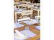 Outdoor dining area with white tables and chairs, set for a meal at 22 Airline Ne St # 403, Atlanta, GA 30312