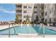 Inviting outdoor pool with comfortable lounge chairs and sunny sky and modern building in the background at 22 Airline Ne St # 403, Atlanta, GA 30312