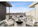 Stylish rooftop patio featuring a modern fire pit, comfortable seating, and city views at 22 Airline Ne St # 403, Atlanta, GA 30312