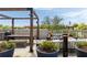 Relaxing rooftop patio with stylish pergola, fire pit, and cushioned seating with skyline views at 22 Airline Ne St # 403, Atlanta, GA 30312