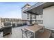 Rooftop patio featuring a grill, dining table, and seating, perfect for outdoor entertaining at 22 Airline Ne St # 403, Atlanta, GA 30312