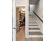 Hallway with a staircase and an open closet filled with shoes and clothes at 22 Airline Street Ne # 403, Atlanta, GA 30312