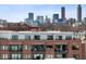 Brick apartment building with balconies featuring views of the city skyline at 22 Airline Ne St # 403, Atlanta, GA 30312