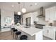 Open-concept kitchen with a large island, stainless steel appliances, and modern pendant lighting at 22 Airline Street Ne # 403, Atlanta, GA 30312