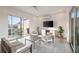 Bright living room featuring a sleek television, plush seating, and sliding glass doors to the outdoor rooftop deck at 22 Airline Ne St # 403, Atlanta, GA 30312