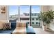 Close up of a living room showing a blue sofa with an animal print throw and pillows, and a houseplant near the window at 22 Airline Ne St # 403, Atlanta, GA 30312