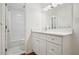 Modern bathroom featuring white cabinetry, quartz countertops, and a tiled shower at 23310 Plantation Dr, Atlanta, GA 30324