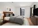 Bedroom featuring hardwood floors, neutral walls, a large window, and modern decor at 23310 Plantation Dr, Atlanta, GA 30324