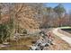 Picturesque creek with natural rock formations and a paved walking trail at 23310 Plantation Dr, Atlanta, GA 30324