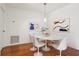 Modern dining room boasts a marble table, tulip chairs, and contemporary artwork at 23310 Plantation Dr, Atlanta, GA 30324