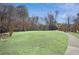 Expansive green space with walking path, tall trees, and manicured lawn at 23310 Plantation Dr, Atlanta, GA 30324