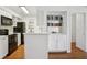 Updated kitchen featuring breakfast bar, white cabinets, and stainless steel appliances at 23310 Plantation Dr, Atlanta, GA 30324