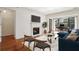 Living room features a fireplace, TV, blue sofa, desk in background, and balcony access at 23310 Plantation Dr, Atlanta, GA 30324