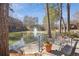 Scenic pond view with a fountain, landscaped grounds, and walking path at 23310 Plantation Dr, Atlanta, GA 30324