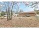 Expansive backyard showing a concrete patio and surrounding foliage, providing plenty of room for recreation at 301 Lady Agatha Ct, Jonesboro, GA 30236