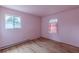 Bedroom featuring hardwood floors and windows; the pink walls bring in a bright and airy feel at 301 Lady Agatha Ct, Jonesboro, GA 30236