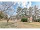 Charming brick home with attached garage and inviting front porch, surrounded by mature trees and a lush lawn at 301 Lady Agatha Ct, Jonesboro, GA 30236