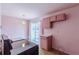 This pink kitchen is set up with an electric range and sliding glass doors to the exterior at 301 Lady Agatha Ct, Jonesboro, GA 30236