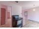 The pink kitchen features an electric range, an eat in space, and a view to a door at 301 Lady Agatha Ct, Jonesboro, GA 30236