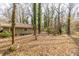 Backyard with trees featuring house and a covered carport at 3483 Napoleon St, Atlanta, GA 30337