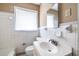 Modest bathroom featuring a sink, toilet, and window with natural light at 3483 Napoleon St, Atlanta, GA 30337