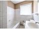 Bright bathroom with a combined tub and shower, with a window for natural light at 3483 Napoleon St, Atlanta, GA 30337