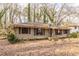 Charming single-story home featuring a classic design, surrounded by a peaceful landscape filled with mature trees and foliage at 3483 Napoleon St, Atlanta, GA 30337