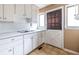 Simple kitchen featuring white cabinets, double windows, and a white door at 3483 Napoleon St, Atlanta, GA 30337