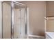 Close-up of a shower stall with glass doors in a neutral-toned bathroom at 3483 Napoleon St, Atlanta, GA 30337