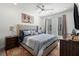 Bright bedroom with a ceiling fan, large bed, white walls, and gray and blue accents at 383 Grant Se Cir # 1634, Atlanta, GA 30315