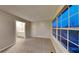 Sunlit bedroom with plush carpet, neutral paint, and a large window with neighborhood views at 640 City Park Dr, Mcdonough, GA 30252