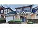 Inviting home exterior featuring stone accents, a blue front door, and an attached garage at 640 City Park Dr, Mcdonough, GA 30252