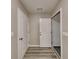 Hallway with hardwood floors, neutral paint, and access to rooms, creating an inviting transition space at 640 City Park Dr, Mcdonough, GA 30252