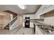 Efficient kitchen with white cabinets, modern appliances, and hardwood flooring at 640 City Park Dr, Mcdonough, GA 30252