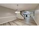 Bright living room with wood flooring, staircase, and open access to a modern kitchen at 640 City Park Dr, Mcdonough, GA 30252