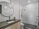 Modern bathroom featuring a glass shower, white subway tile, and starburst light fixtures at 650 Jones Rd, Roswell, GA 30075