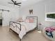 Bright bedroom with a bed, a window, a barn door to the en suite bath, and wood floors at 650 Jones Rd, Roswell, GA 30075