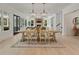 Bright, open dining room with farmhouse table, chairs, and modern lighting fixtures at 650 Jones Rd, Roswell, GA 30075